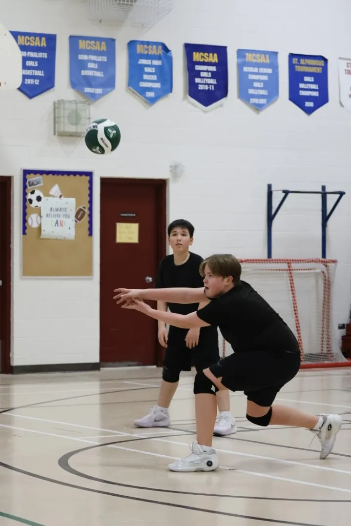 Two boys passing during a volleyball practice session