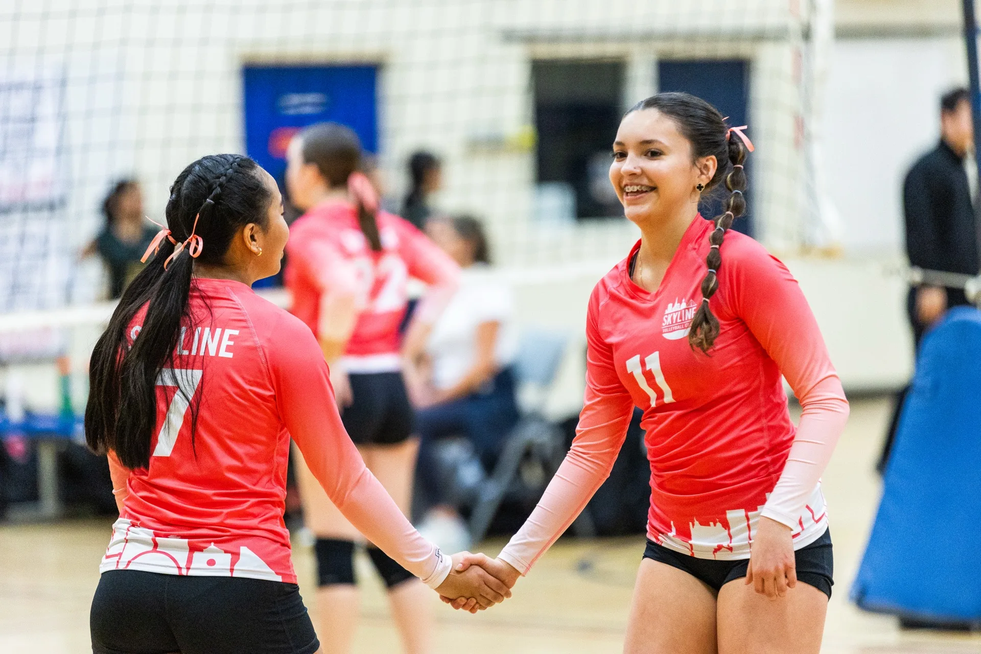 Skyline Volleyball Club athletes celebrating together on the court