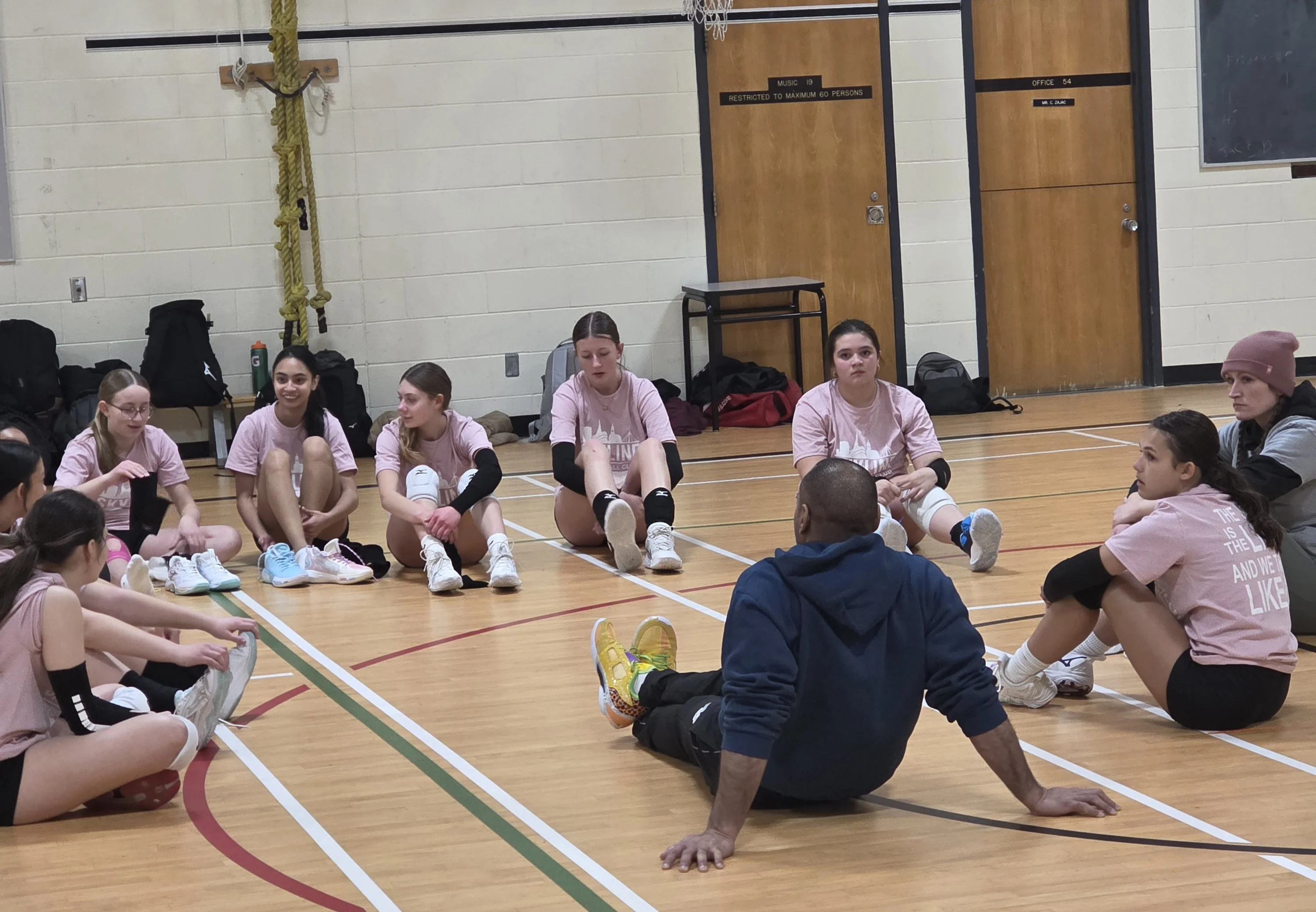 Volleyball coaches and athletes at an affiliate club training session