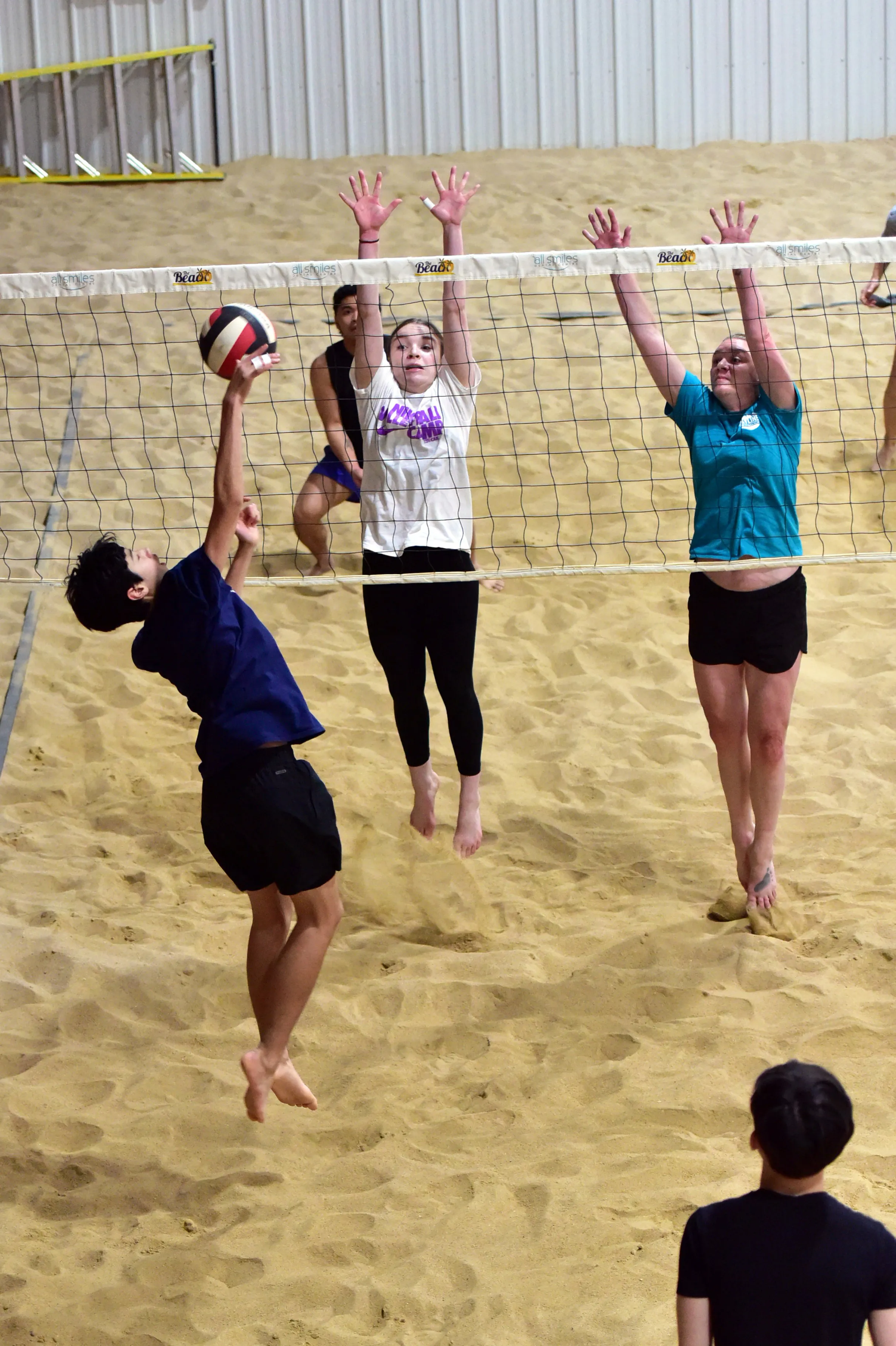 Athletes at the net during a beach volleyball session