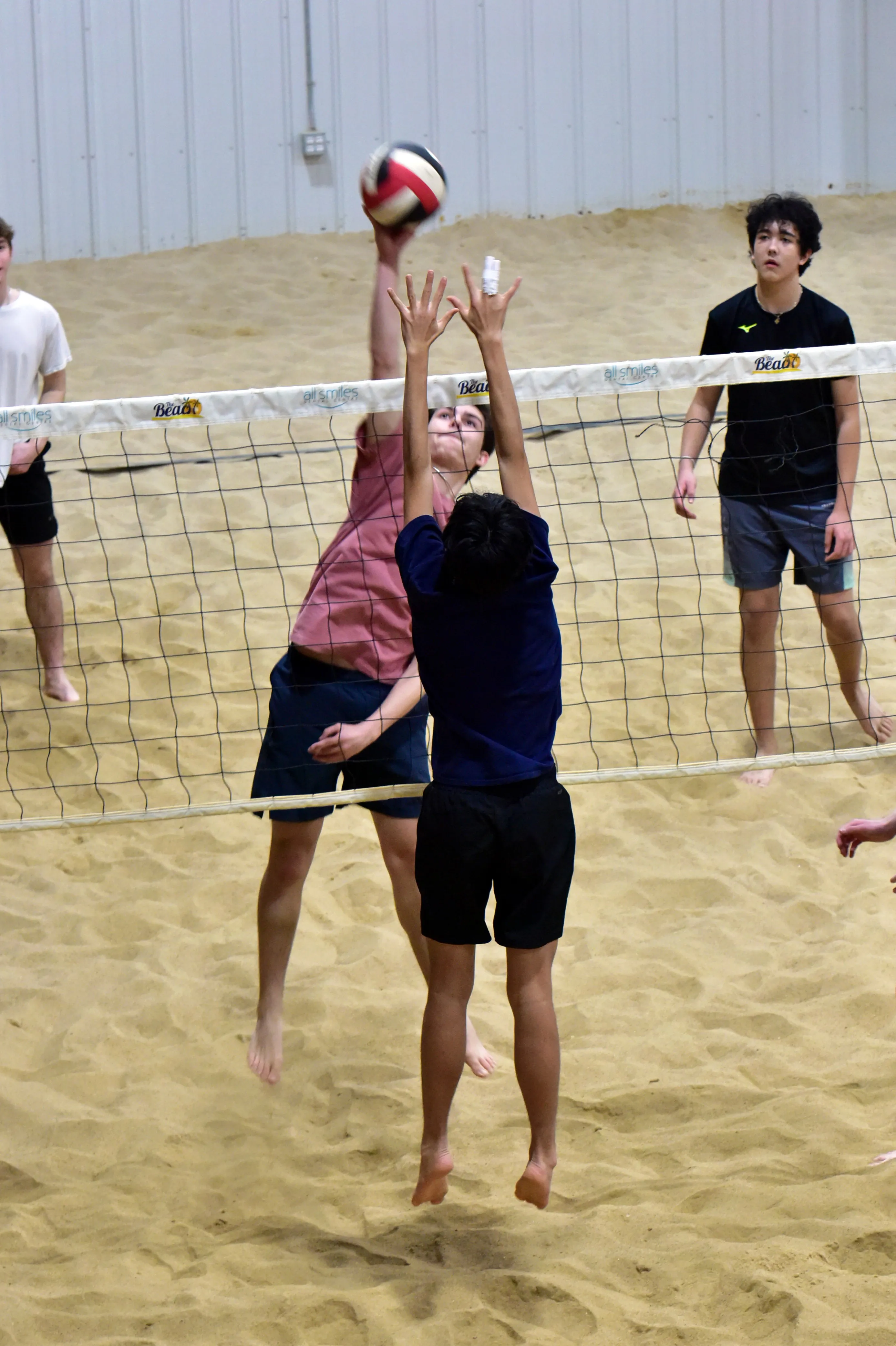 Boys playing beach volleyball during a training session