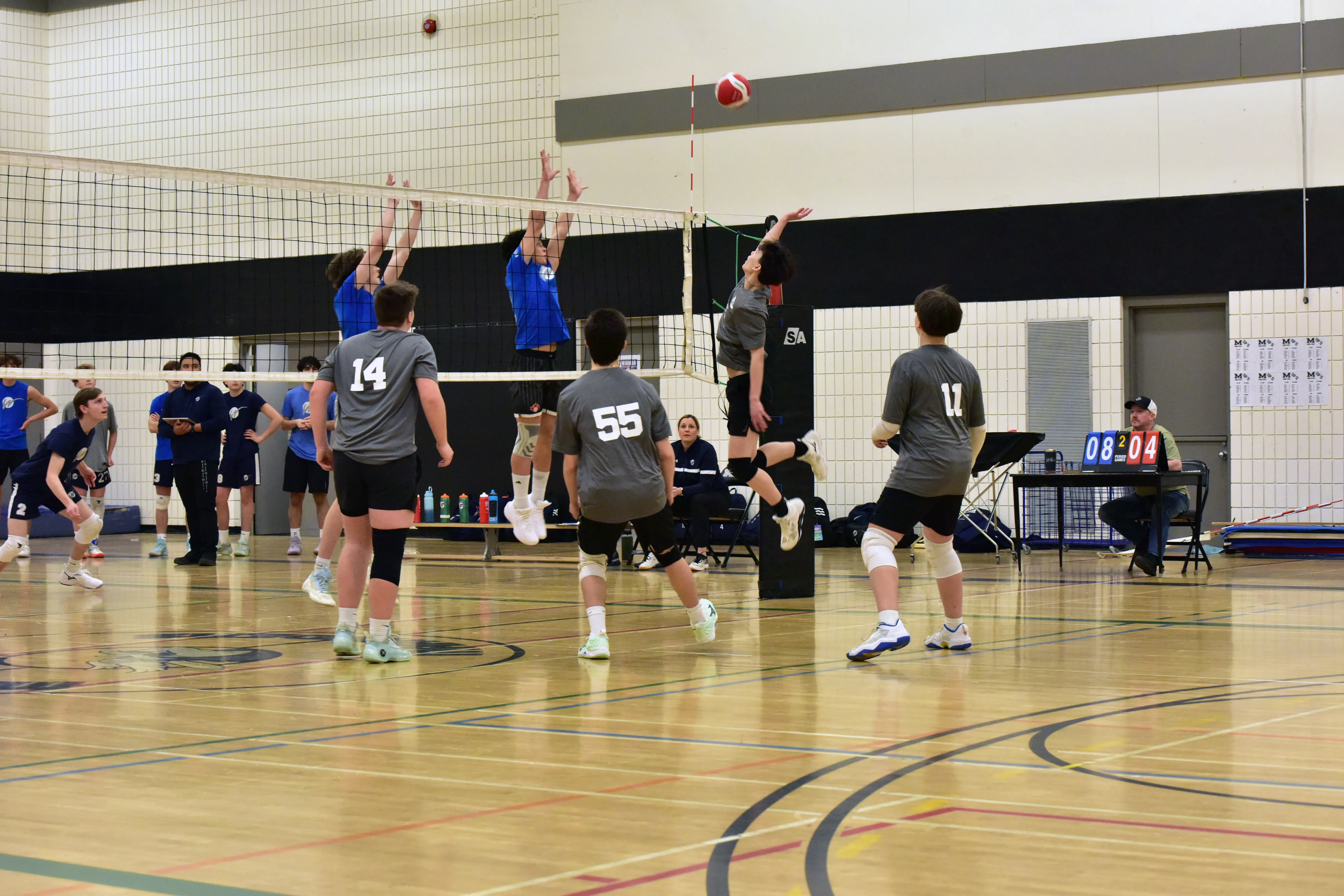 Athletes blocking at the net during practice
