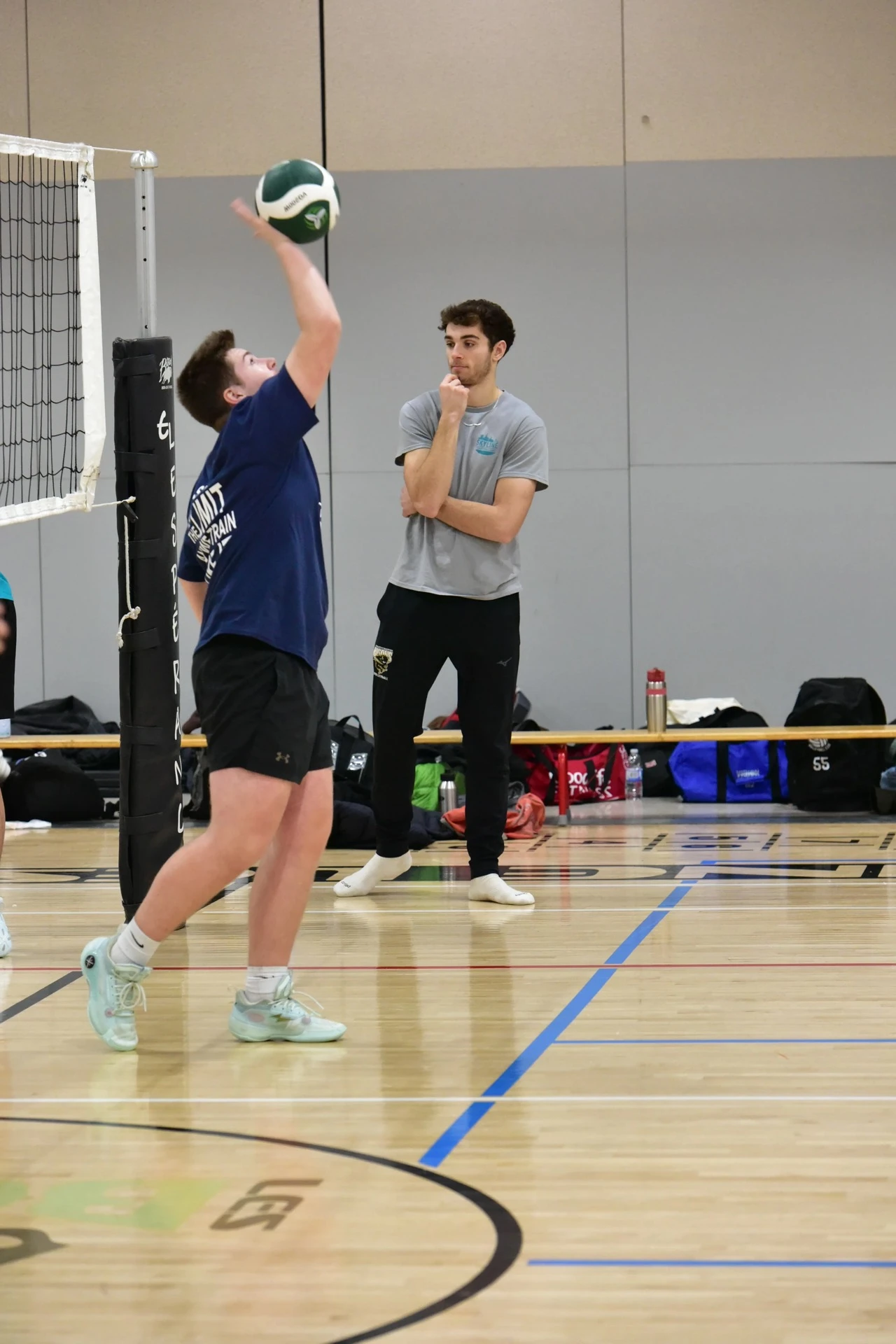 Coach providing individual feedback to a young athlete